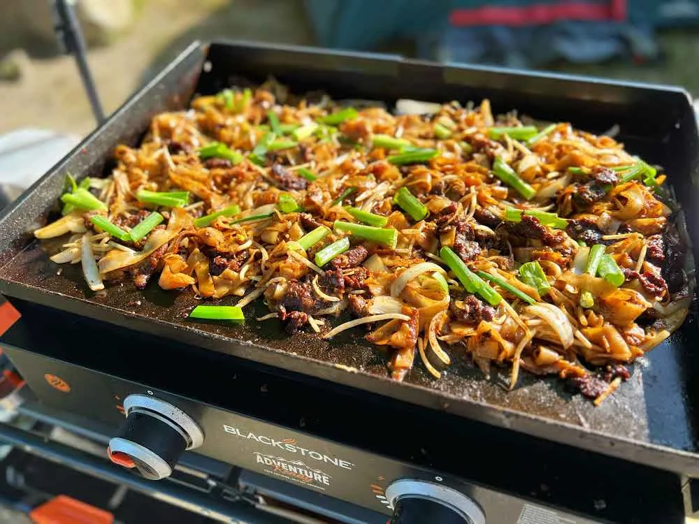 "Cooking on a Blackstone Grill outdoors."