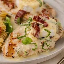 "Delicious Chicken Bryan with goat cheese, sun-dried tomatoes, and lemon butter sauce."