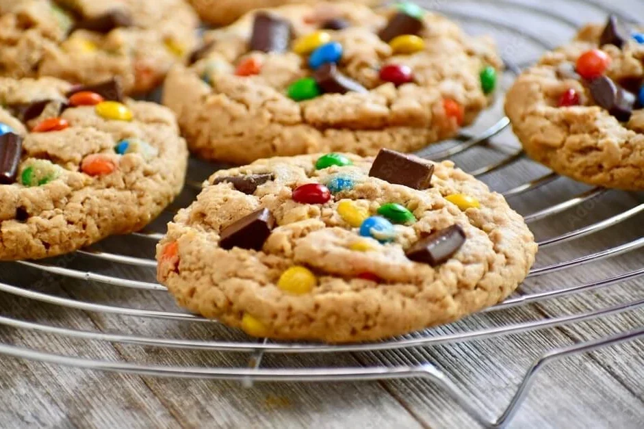 "Freshly baked monster cookies with colorful M&M's."